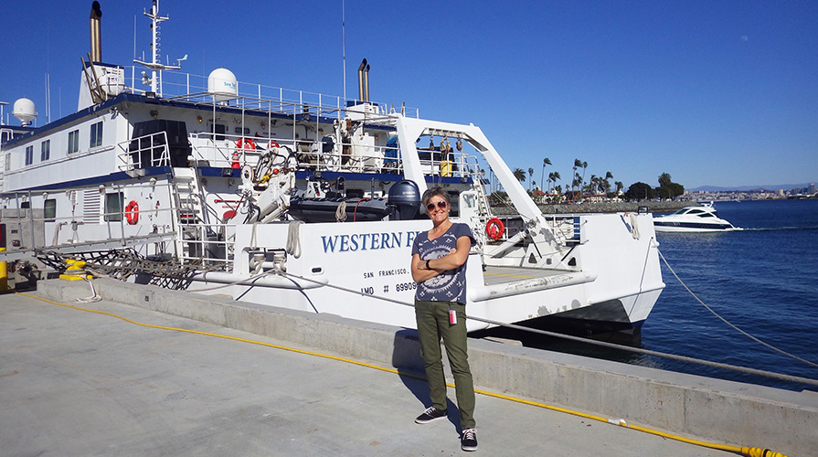 Professor Shana Goffredi in front of a research ship