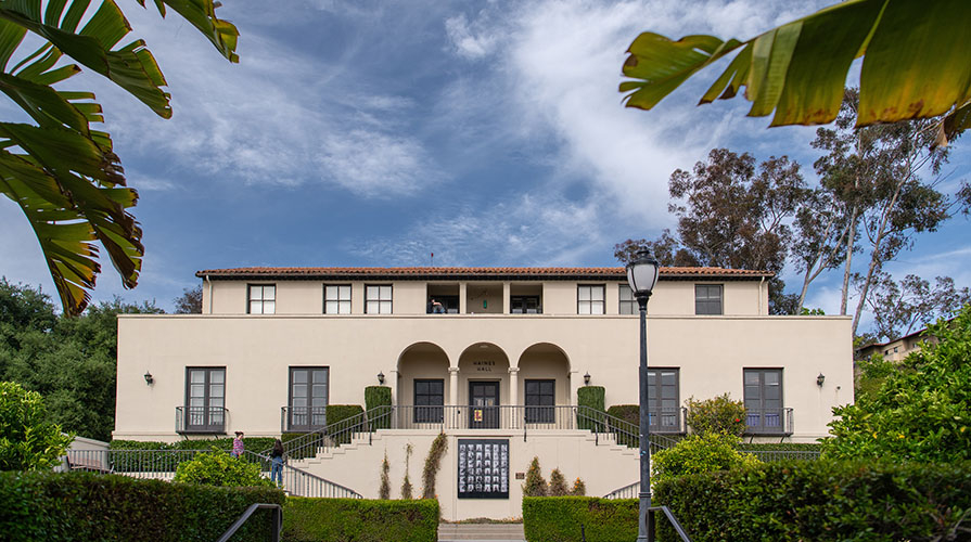 a front view of Haines Residence Hall with blue sky and clouds