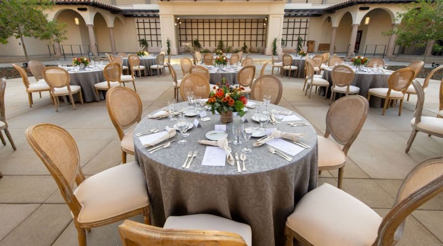 Tables arranged with table settings in a courtyard