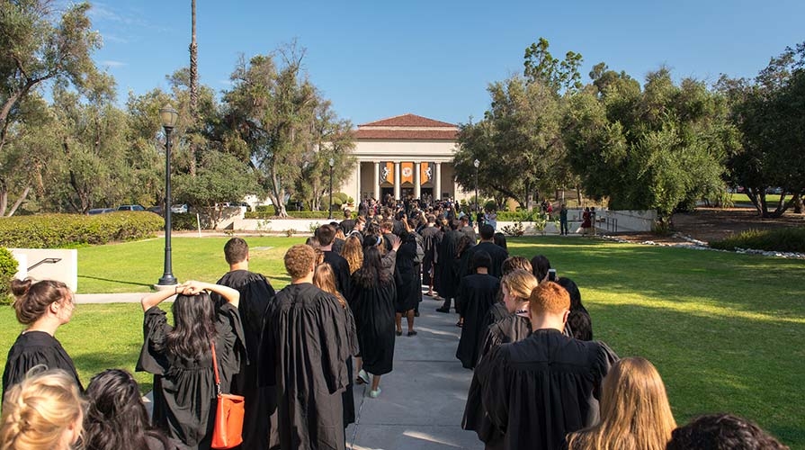Students march towards Thorne Hall for Convocation