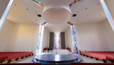 The interior of Herrick chapel showing a central opening and stained glass