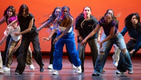 Dance Pro student dancers doing a hip hop routine with a red background