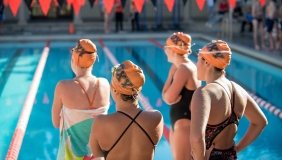 Oxy swimmers standing near the pool