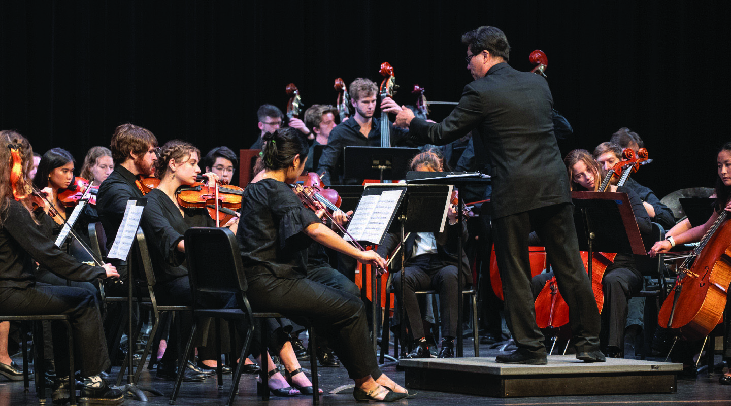 Chris Kim, the Choi Family Director of Instrumental Music, conducts the Occidental Symphony in a performance of Michael Jackson’s “Human Nature.”