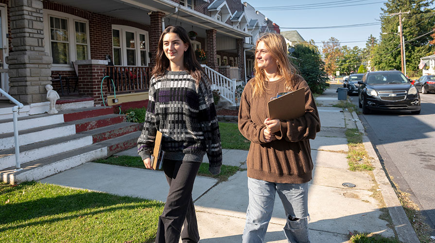 Two female Occidental College students walking door to door on the streets of Allentown, PA as part of their political campaign work