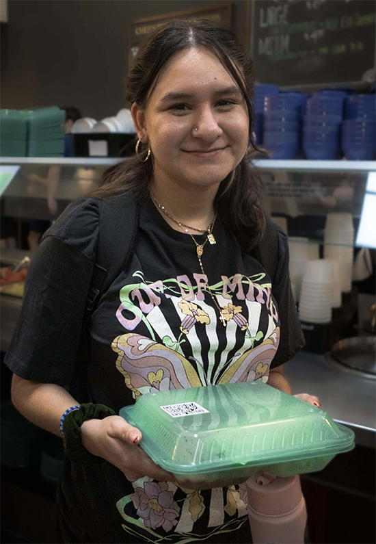 Stephanie Chavez ’24 holds an eco-clamshell container in the Marketplace in September 2023. Photo by Sara Hamid ’26/The Occidental