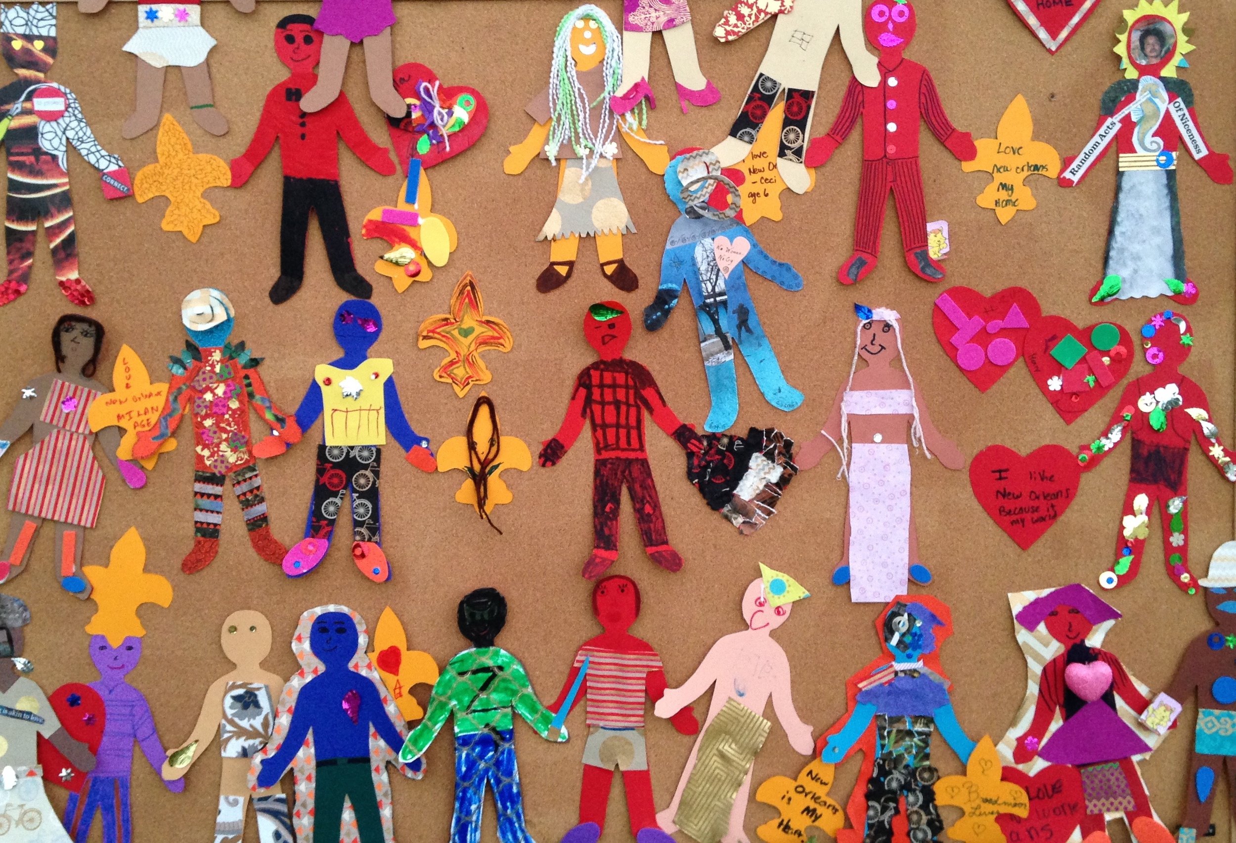 Colorful picture of children&#039;s artwork depicting different figures in brightly colored outfits. 