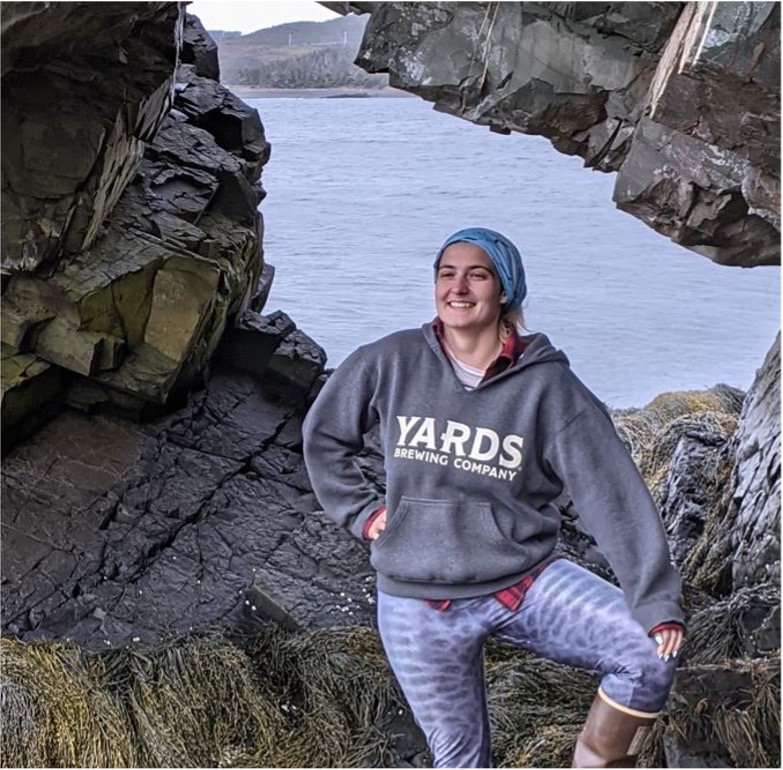 Person in front of rocks and ocean