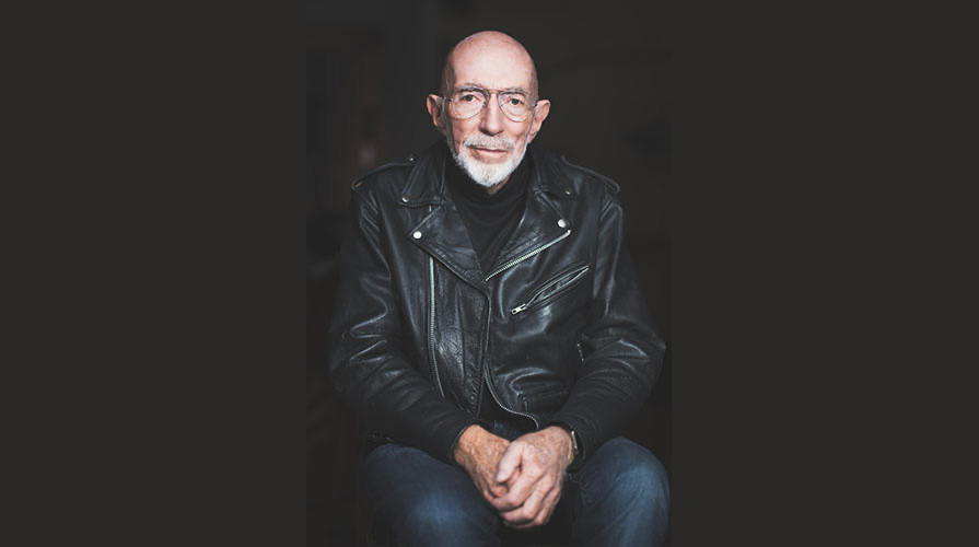 Kip Thorne portrait wearing a black leather jacket