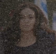 A dark blurry photo of a woman with long dark hair