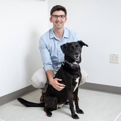 Occidental professor Zachary Silver and his black dog