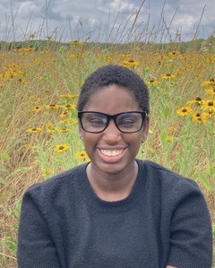 Woman in front of flowers and sky