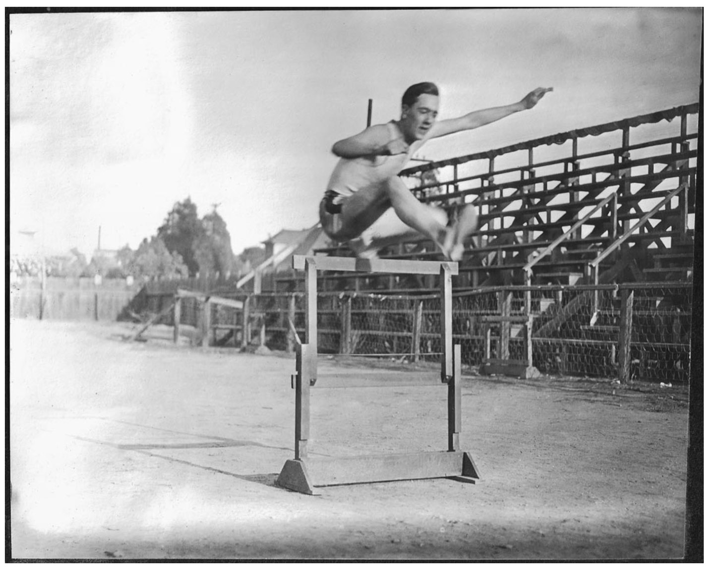 An unidentified Oxy hurdler clears the high hurdles during practice on a track in Highland Park.