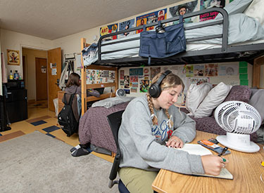 an Occidental student studying at her desk in her residence hall room