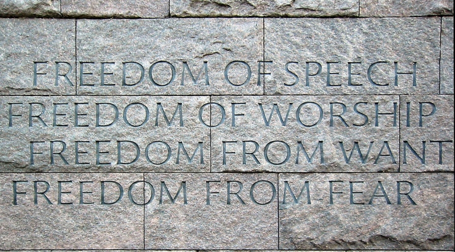 Text engraved on stone blocks reading: "Freedom of Speech / Freedom of Worship / Freedom from want / Freedom from fear"