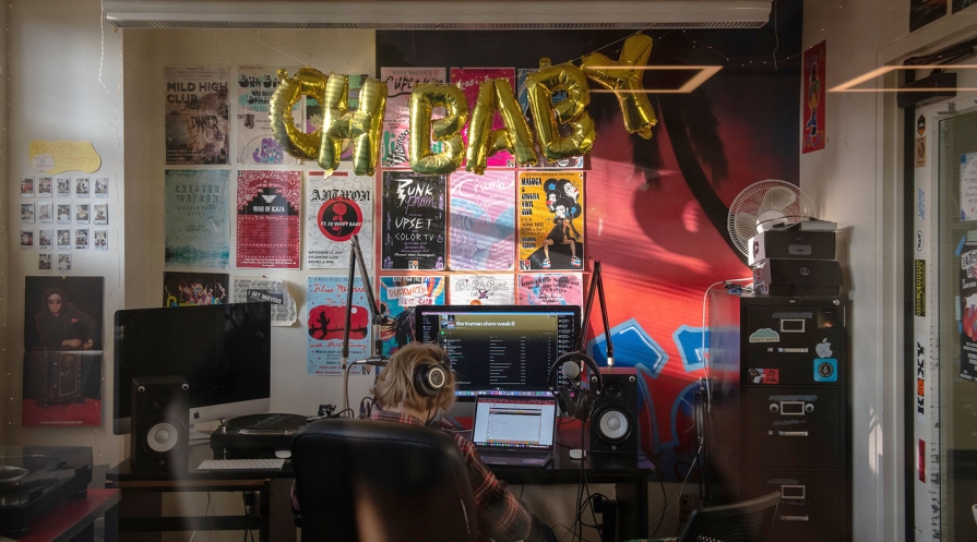 a student in the dj booth at the KOXY radio station