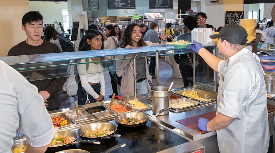 students ordering food at the dining counter in the Marketplace