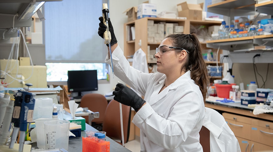 Occidental College student Joan Kronick in the lab at the City of Hope National Medical Center.