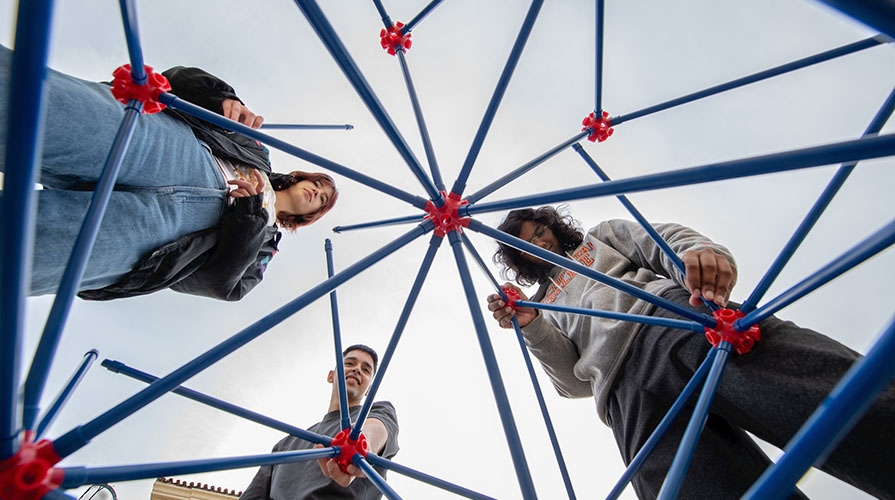 Three Occidental College students assembling a Sierpinski octahedron