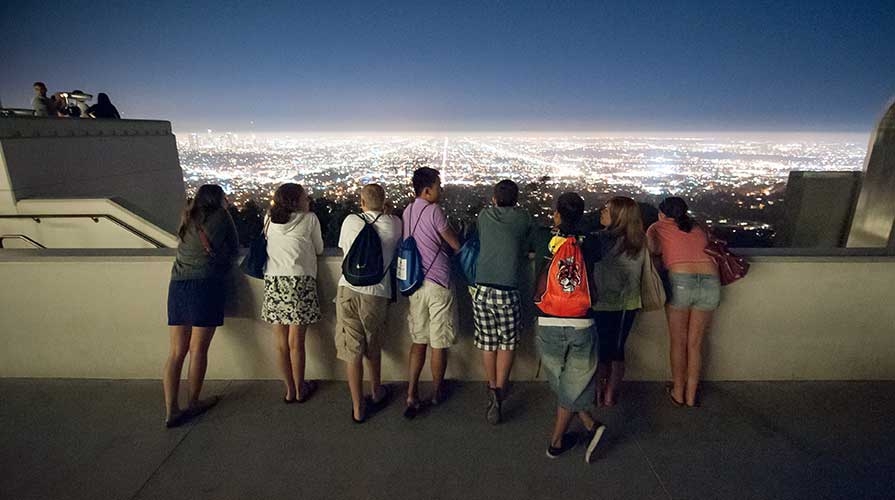Students overlooking LA at night at Griffith Observatory