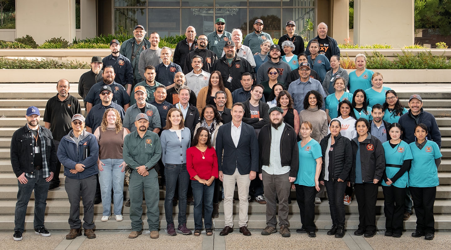 A large group of Facilities Management staff on the steps at Occidental College