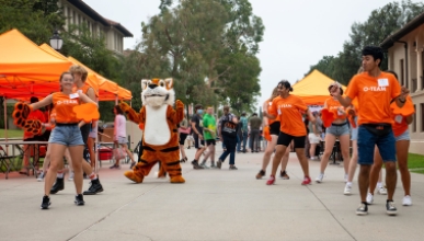 Oswald on the Quad with O-Team Members dancing