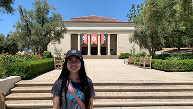 Oxy student Thina Ly stands in front of Thorne Hall on campus