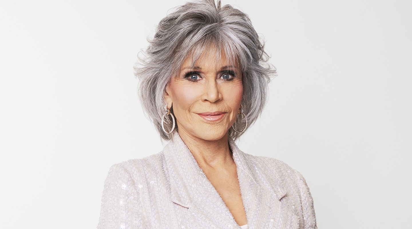 Jane Fonda with short grey hair and a white blazer