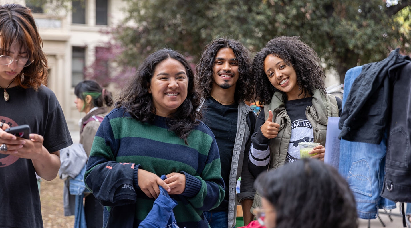 Occidental College students together on campus, smiling