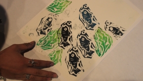 A piece of paper with a fish printed in black and green ink. 