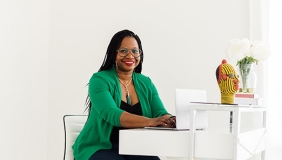 Deirdre Cooper Owens full-body photo with green jacket