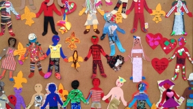 Colorful picture of children&#039;s artwork depicting different figures in brightly colored outfits. 