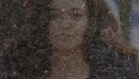 A dark blurry photo of a woman with long dark hair