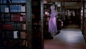 library stacks with a ghost hovering reading a book