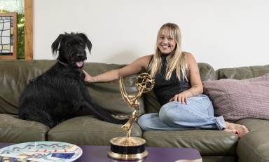 Two-time Emmy winner Emma Choate ’20 with her 2-year-old dog, George.