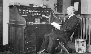 Professor William D. Ward at his desk in the Hall of Letters on Occidental’s Highland Park campus.