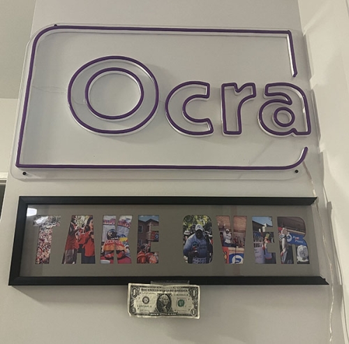 Ocra's first dollar of profit, hanging on an Ocra sign.